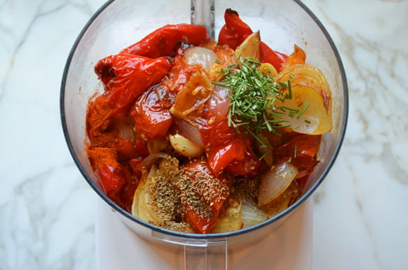 Roasted vegetables and seasonings in a food processor.