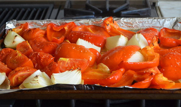 Roasted vegetables on a lined baking dish.