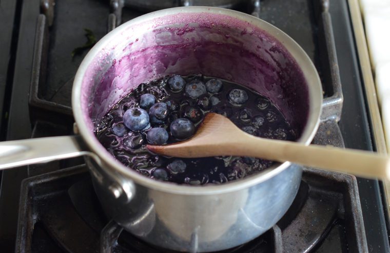 stirring fresh blueberries into cooled syrup