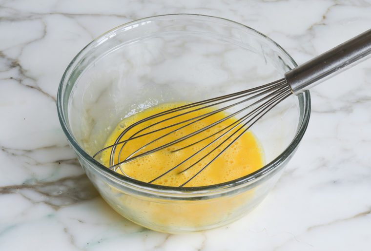 Whisk in a bowl of beaten eggs.