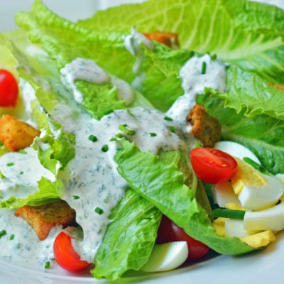 Salad topped with ranch dressing.