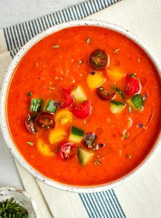 roasted red pepper and tomato gazpacho garnished with diced cucumbers and tomatoes