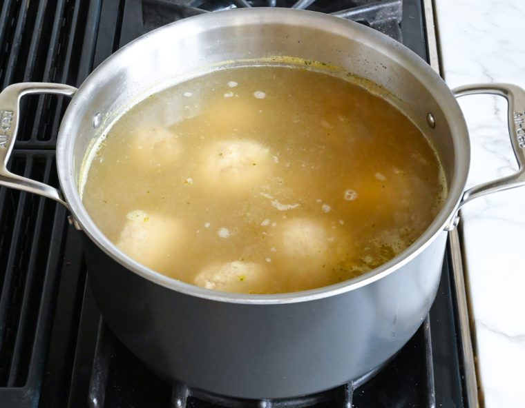 matzo balls simmering in soup