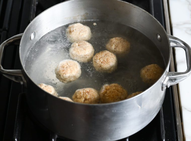 dropping matzo balls into boiling water