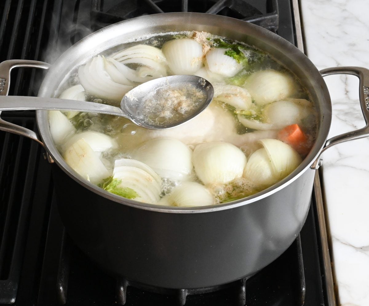 skimming fat from the surface of the soup