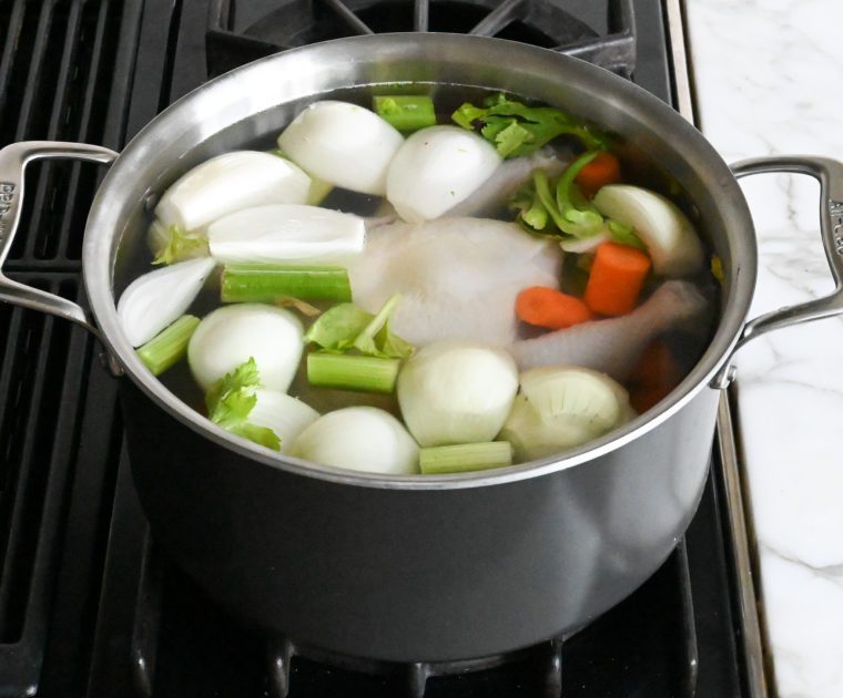 chicken, vegetables, and water in a large soup pot