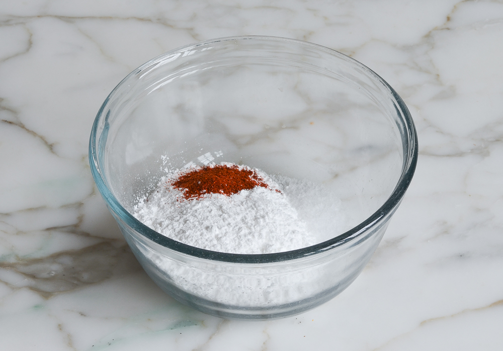 confectioners' sugar, salt, cayenne and water in bowl