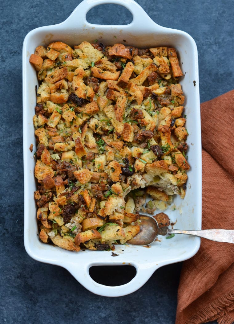 Spoon in a baking dish of sausage and herb stuffing .