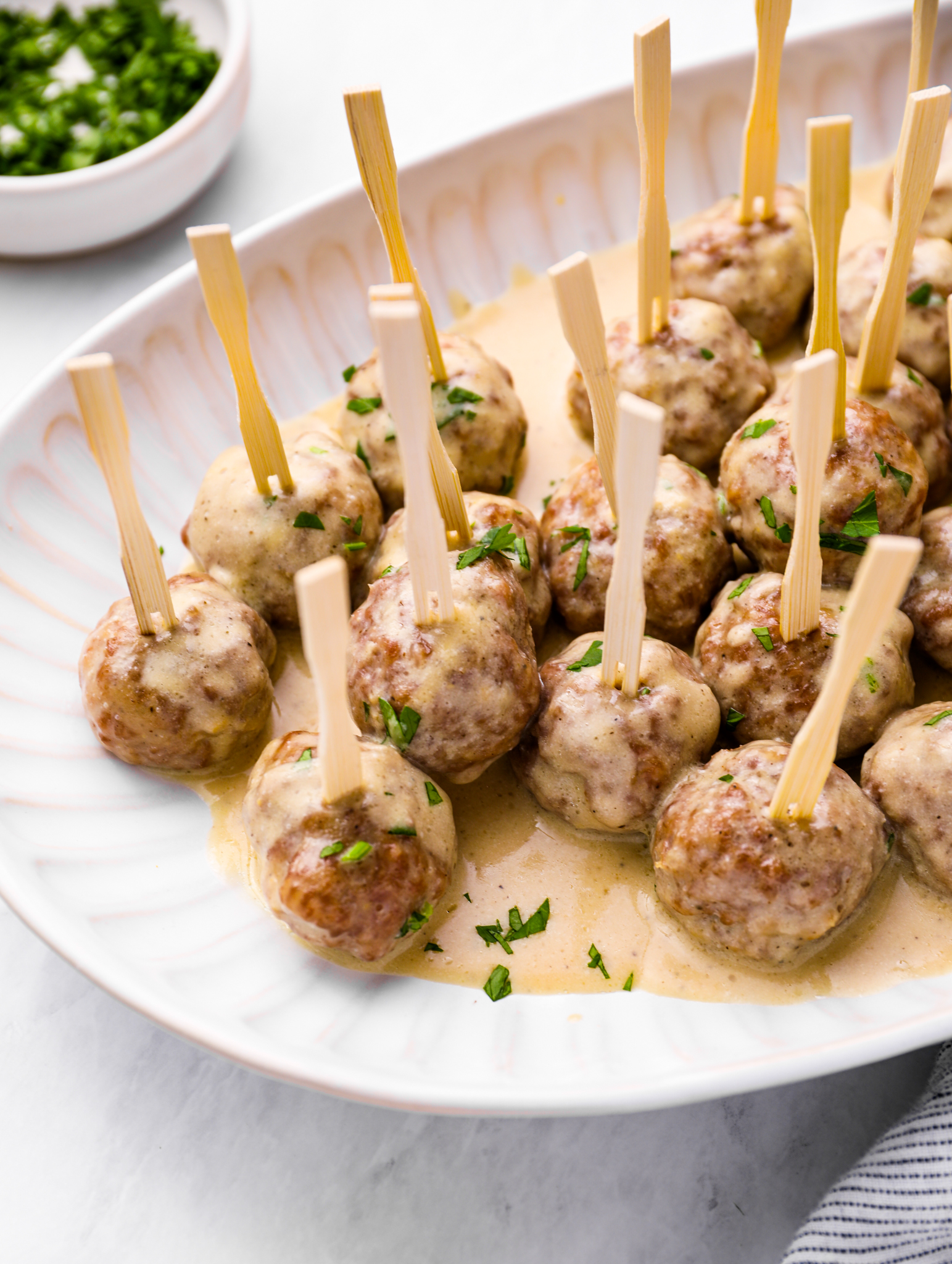 Plate of Swedish meatballs on small skewers.