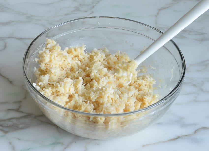 Spatula in a bowl of coconut mixture.