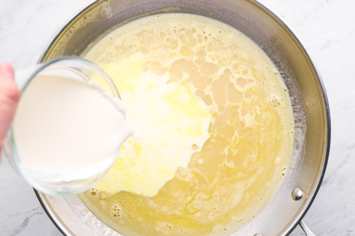 adding the cream to the Swedish meatball sauce