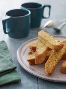 almond biscotti on plate with coffee.