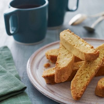 almond biscotti on plate with coffee.