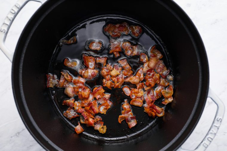 frying the bacon in a Dutch oven