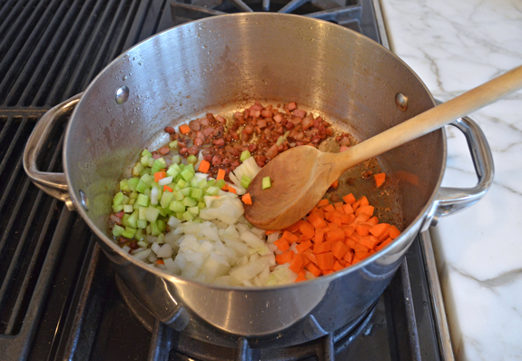 adding veggies to pot for pasta e fagioli