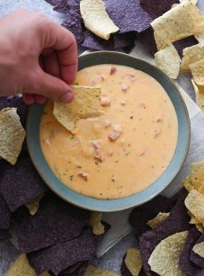 chile con queso with chips on platter