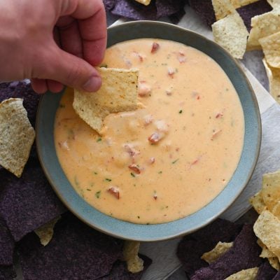 chile con queso with chips on platter