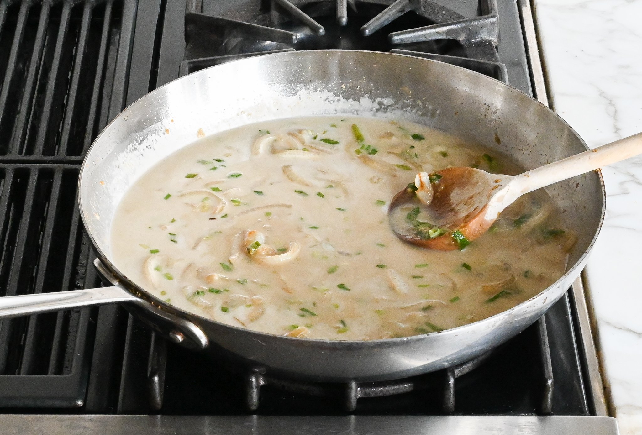 Adding the coconut milk, fish sauce, and sugar to the skillet.