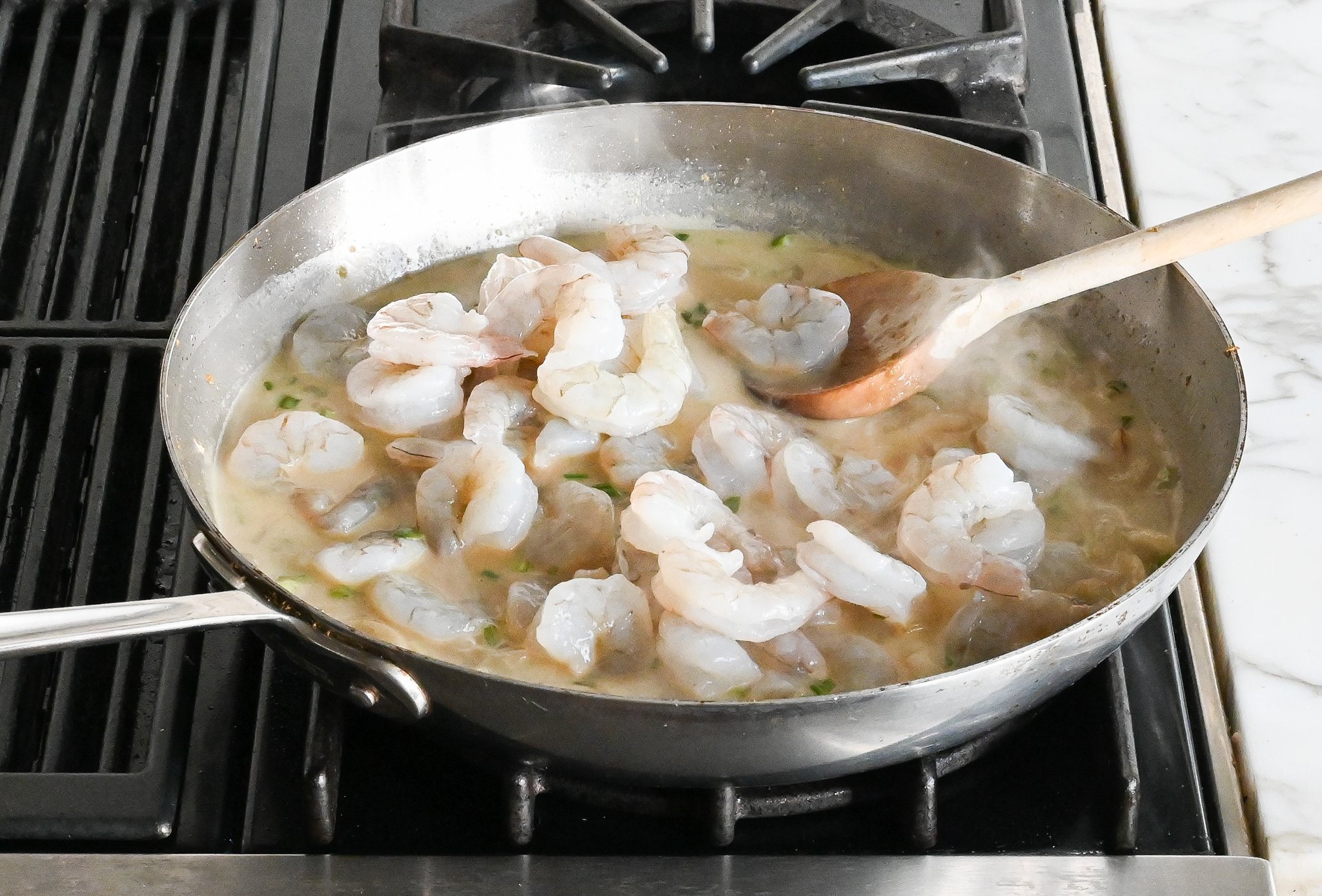 Shrimp cooking in a coconut milk mixture.