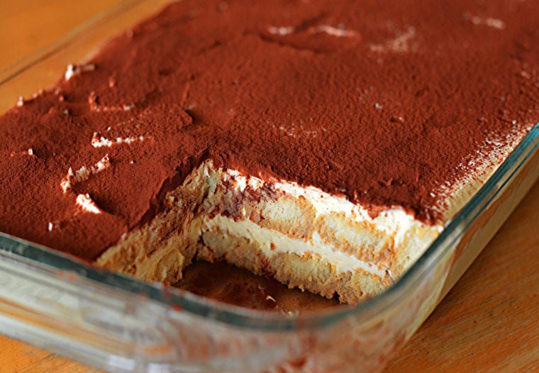 Baking dish of partially-served tiramisu.