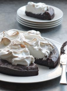 Flourless chocolate cake with meringue missing a slice.