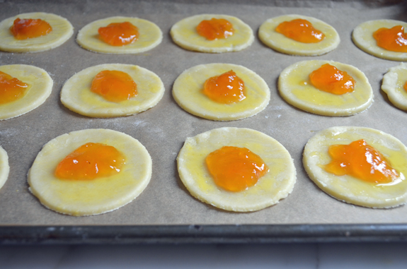 Circles of dough topped with apricot jam.