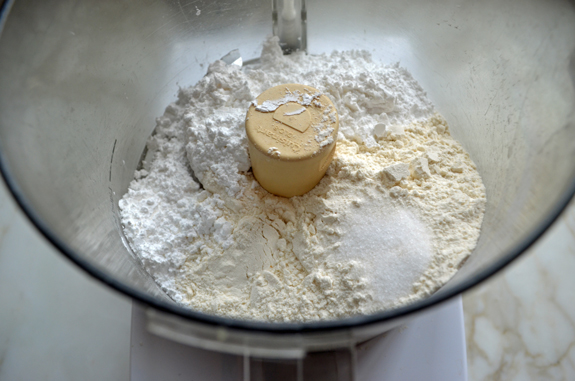 Unmixed dry ingredients in a food processor.