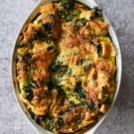 Spinach and cheese strata in a baking dish.