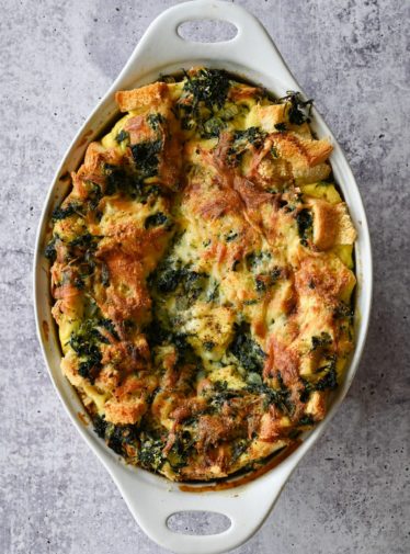 Spinach and cheese strata in a baking dish.