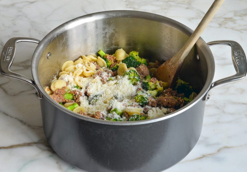 tossing the orecchiette with the sausage and broccoli mixture and cheese