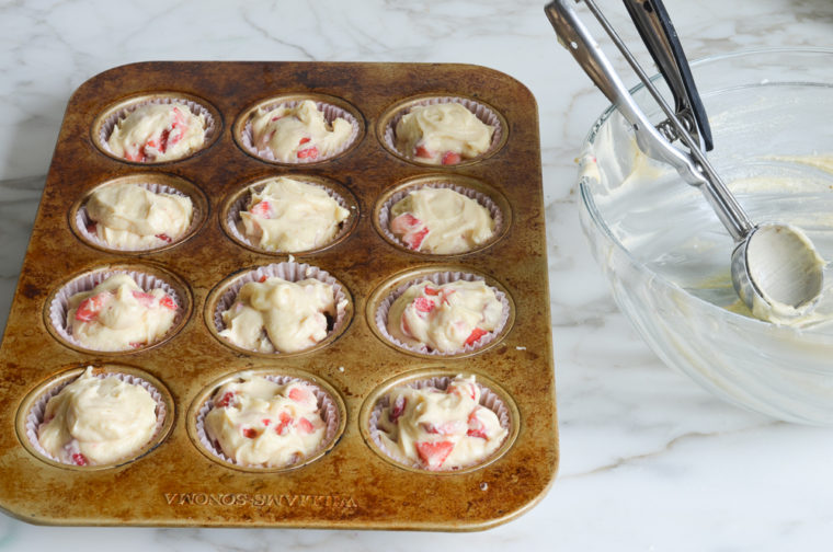 strawberry muffin batter in muffin tin
