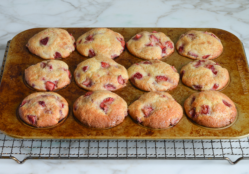baked strawberry muffins cooling on rack
