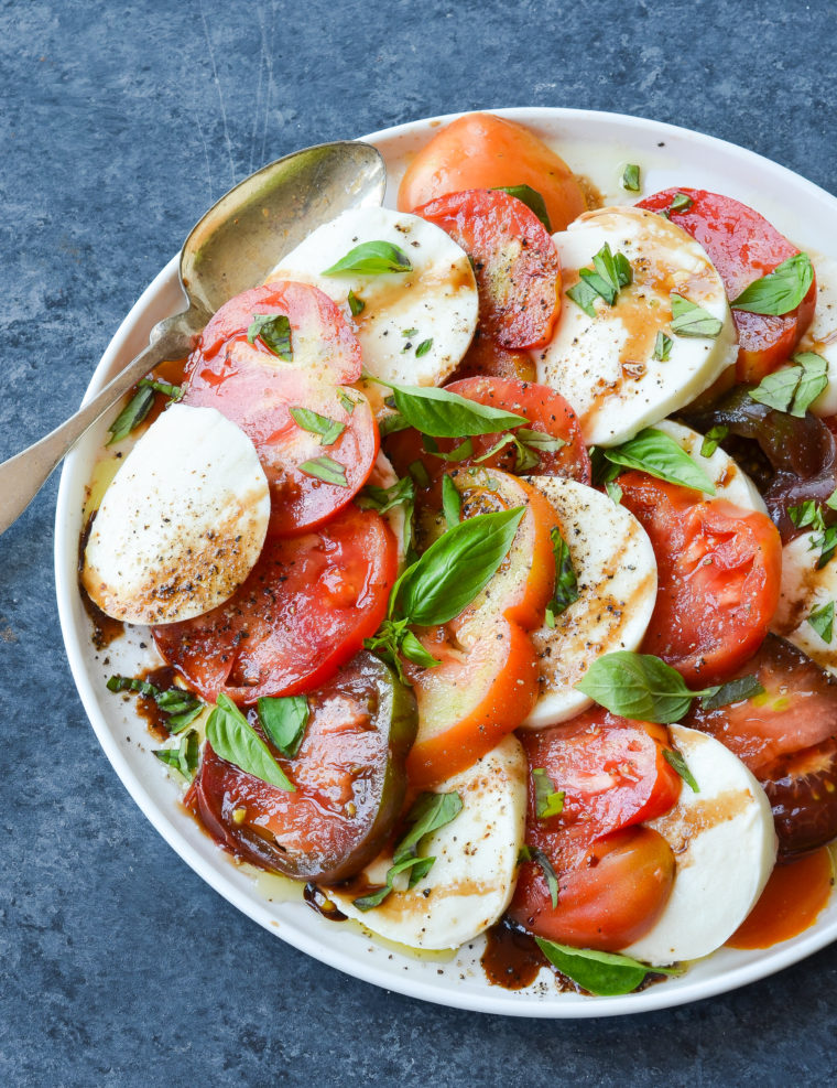 Spoon on a plate of caprese salad.