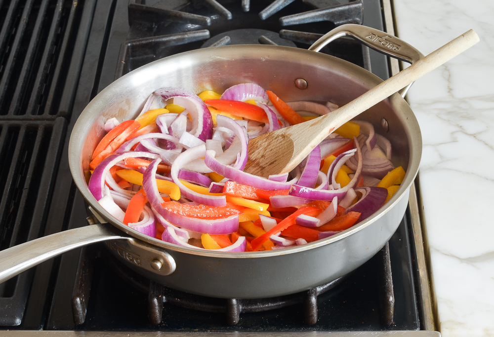 peppers and onions in the skillet