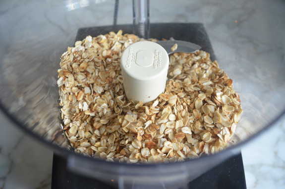 Toasted oats in a food processor.