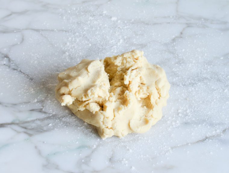cut-out sugar cookie dough on counter