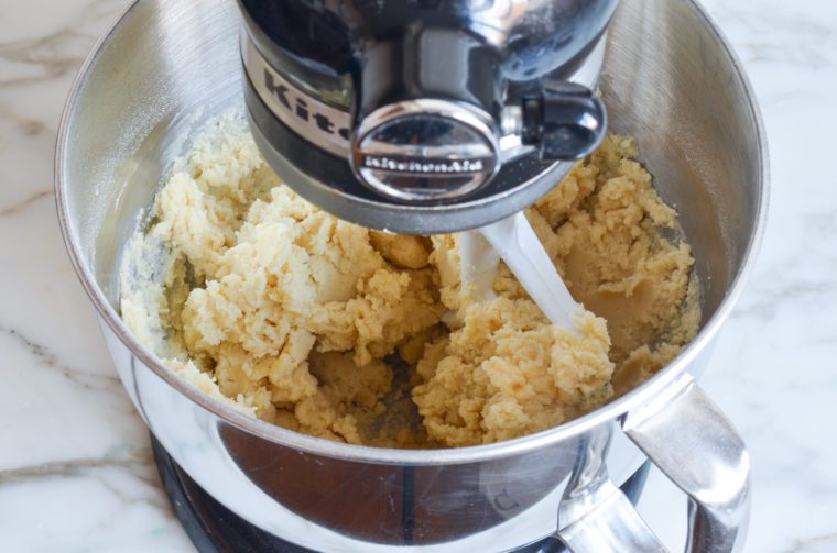 cut-out sugar cookie dough in mixer