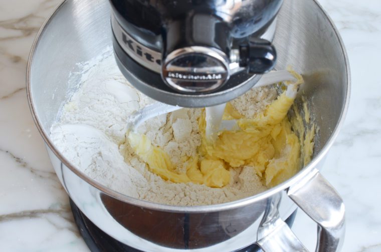 adding the flour to the dough