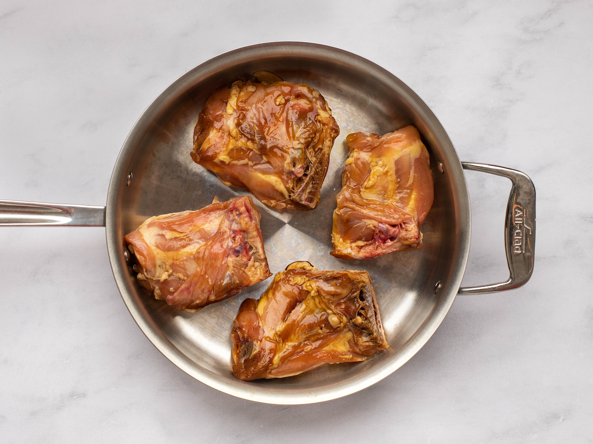 searing the chicken in a skillet