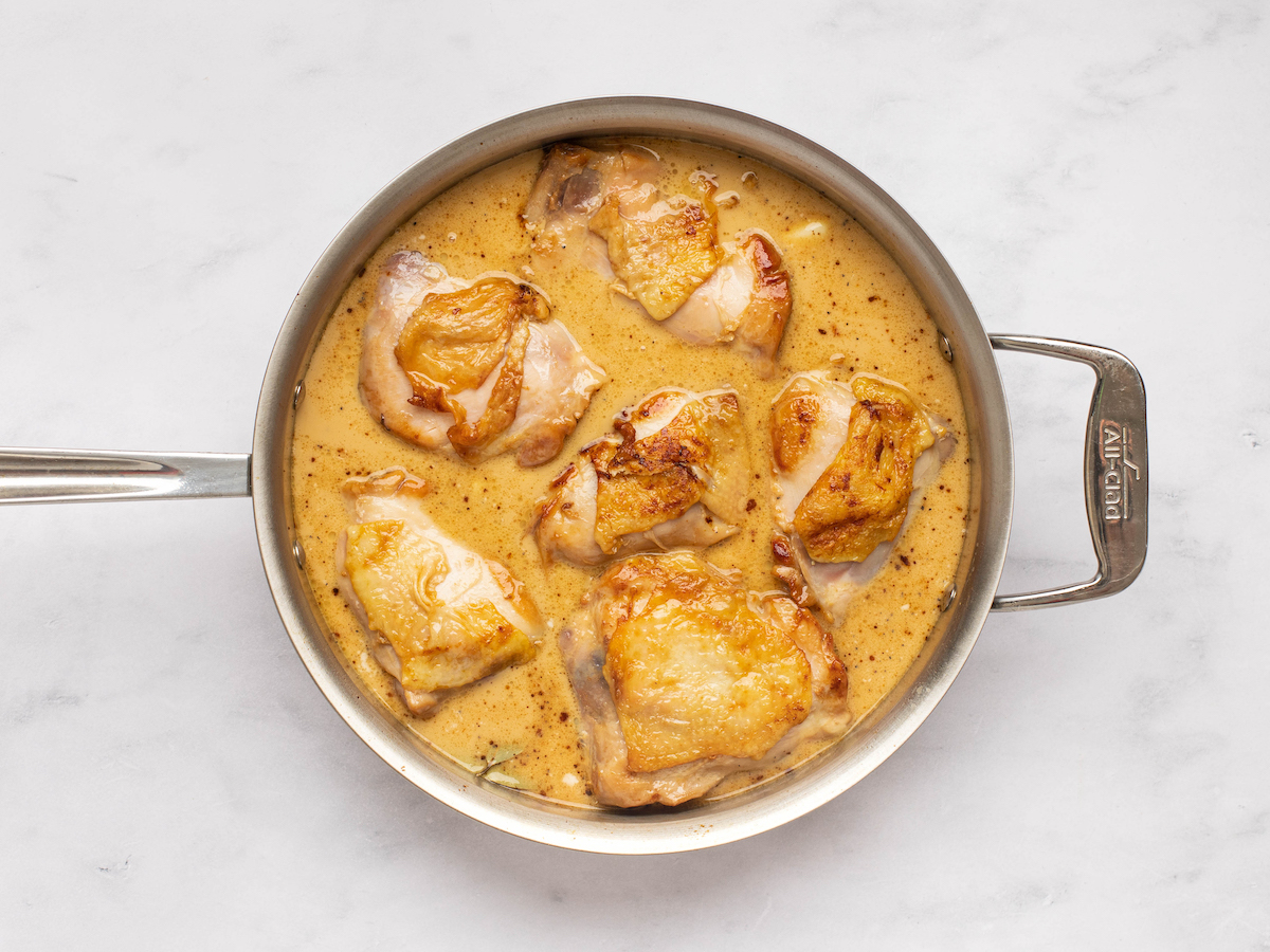 chicken simmering in sauce