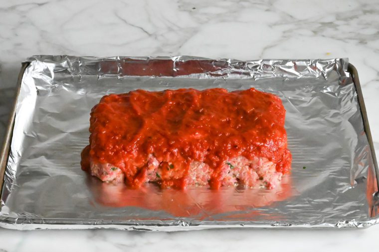 topping italian meatloaf with marinara sauce