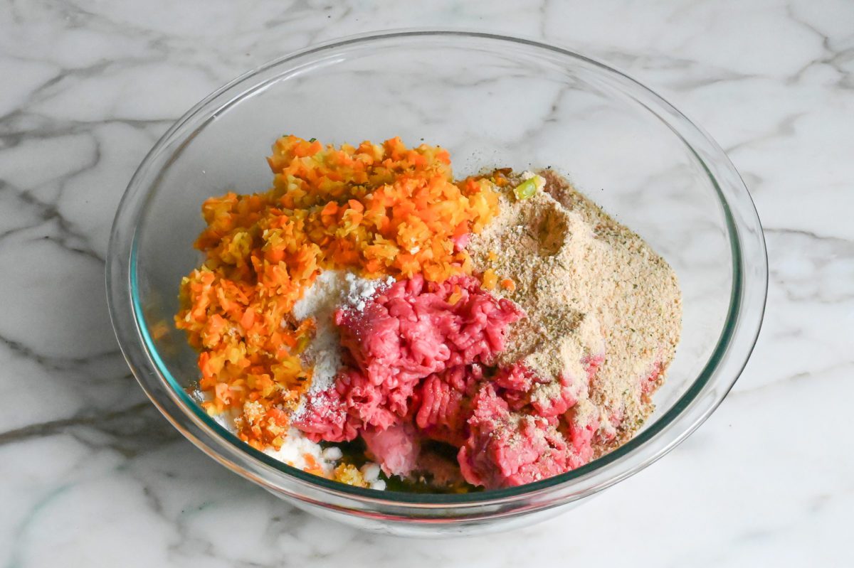 adding the meat, vegetables, bread crumbs and cheese to the egg mixture