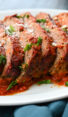 Sliced Italian meatloaf on a platter.