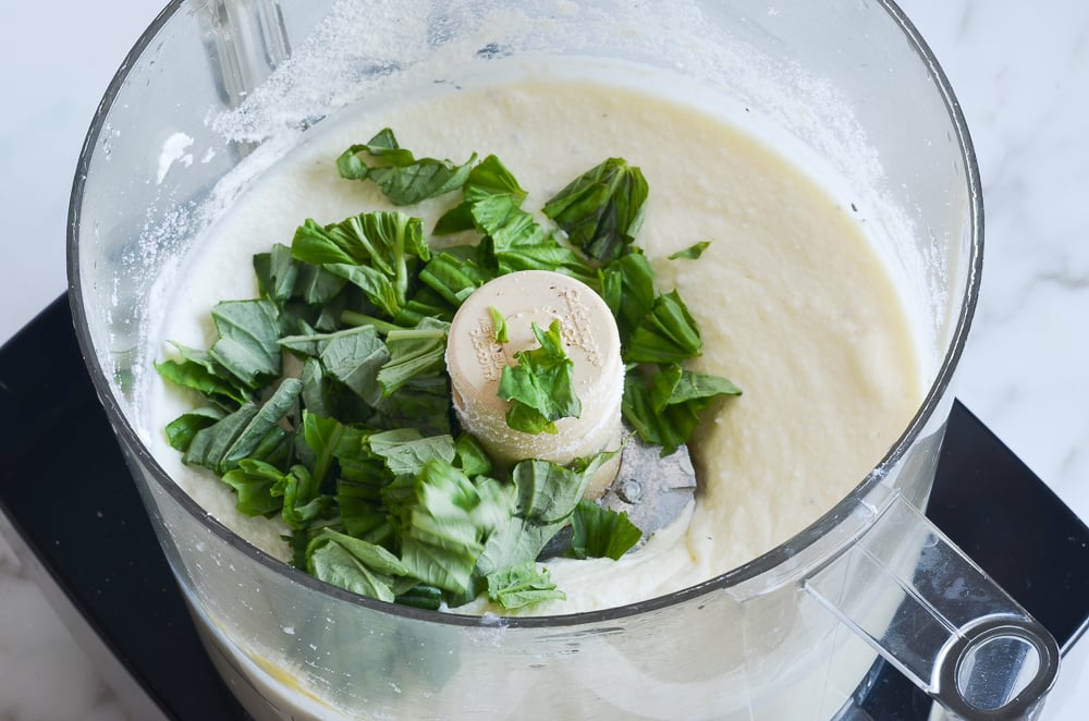adding basil to ricotta mixture