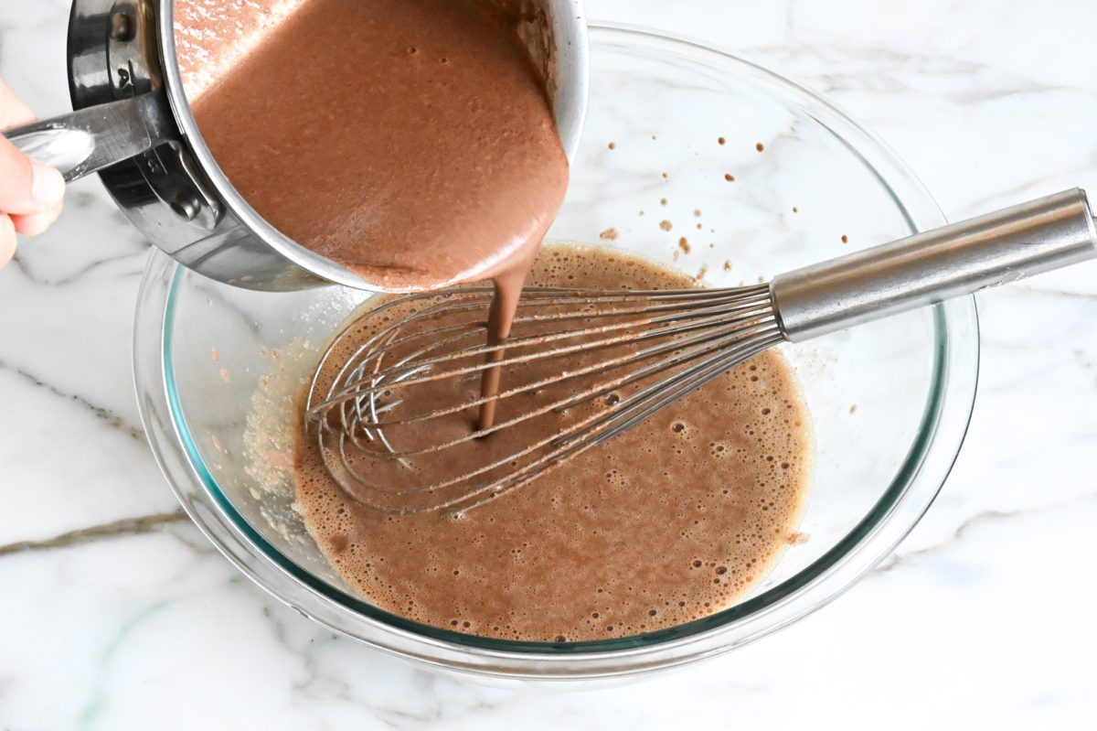 adding the chocolate mixture to the egg mixture