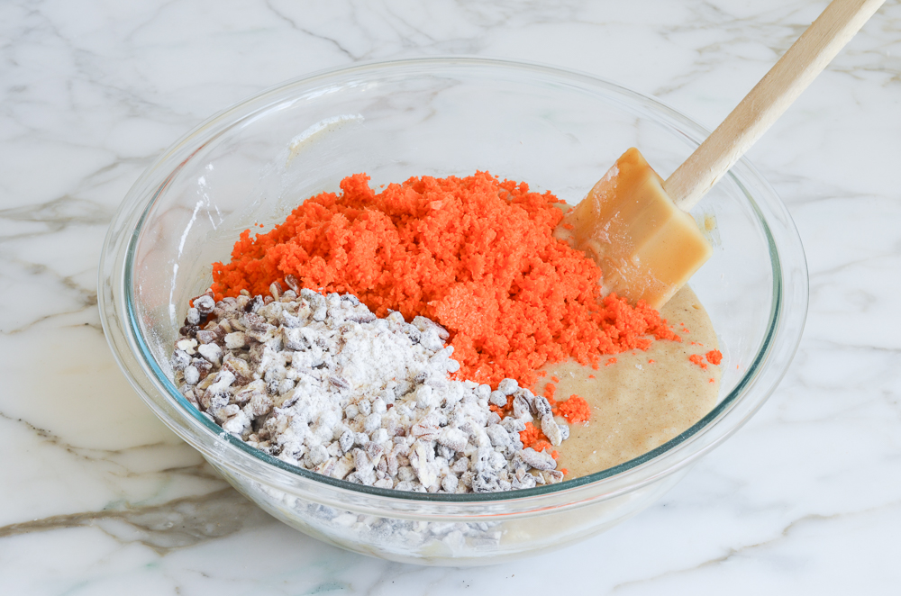 adding carrots, currants and nuts to carrot cake batter