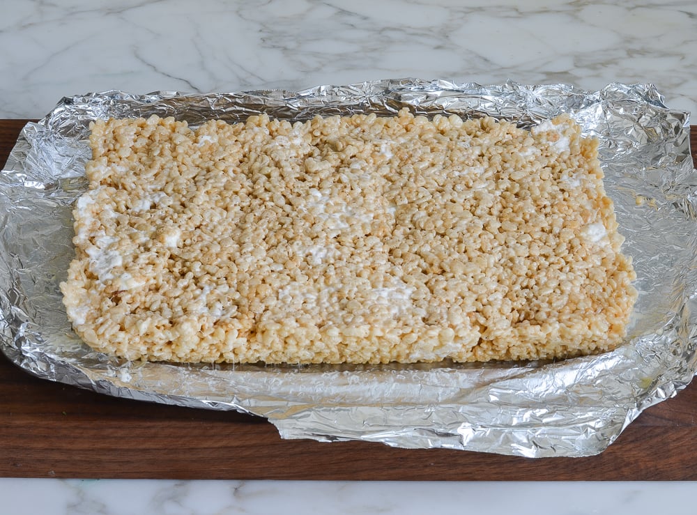 rice krispies treats on cutting board.