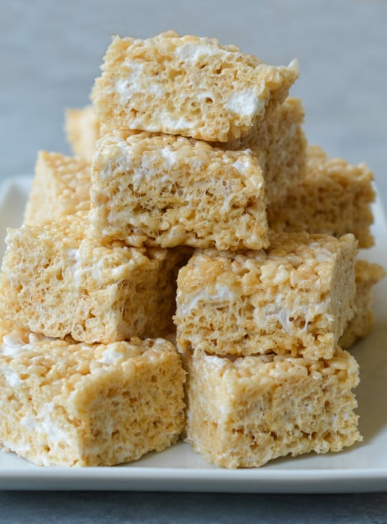 Rice Krispie treats stacked on platter from the best Rice Krispie treat recipe.