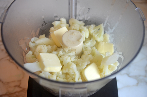 Cooked cauliflower florets and butter in a food processor.