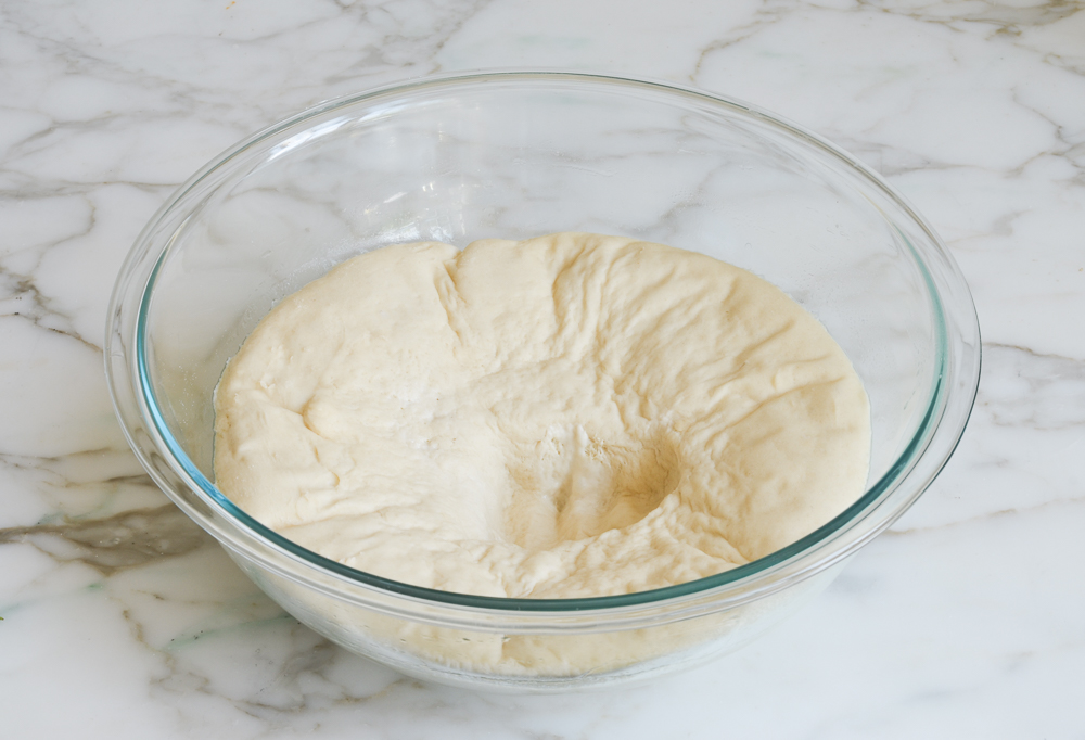punched down dough in bowl
